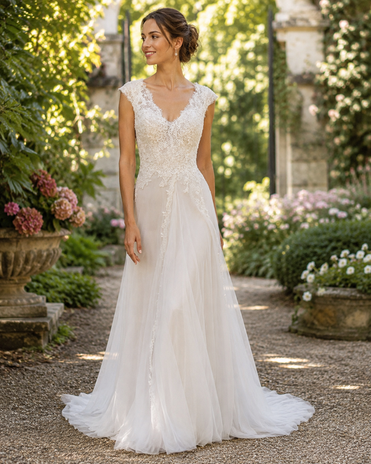 Abito da sposa con gonna ampia, strascico in tulle e corpetto in pizzo rebrodé